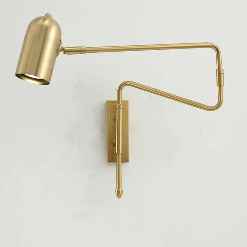 Brass-finished decorbites adjustable long-arm wall lamp with sleek articulated arm and cylindrical shade for bedroom use