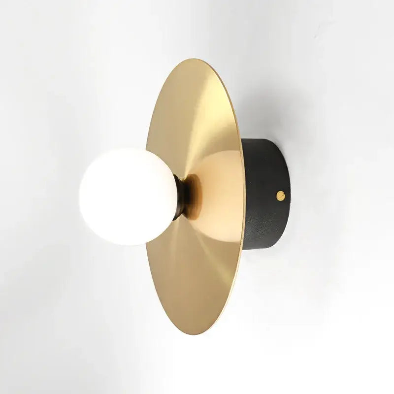 Modern black and brass light fixture wall sconce with brushed gold circular shade and white glass ball bulb decorbites golden glass