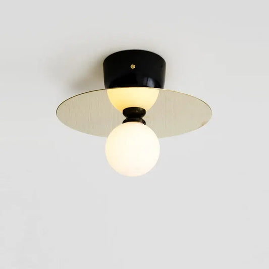 Modern black and brass light fixture with spherical frosted glass bulb wall sconce by decorbites golden glass