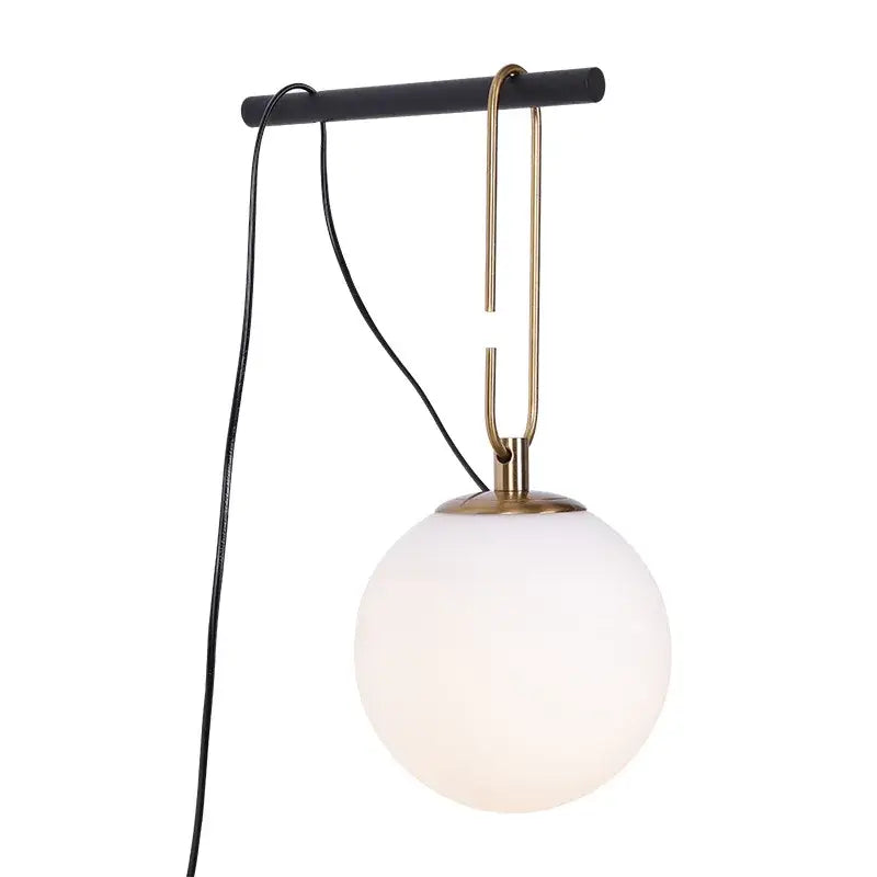 Minimalist pendant light with frosted glass ball shade and brass hook from a matte black bar for bedroom decorbites decor