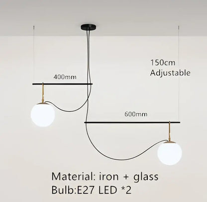 Adjustable modern black and brass pendant light with two glass ball bulbs suspended from iron frame for bedroom decorbites decor