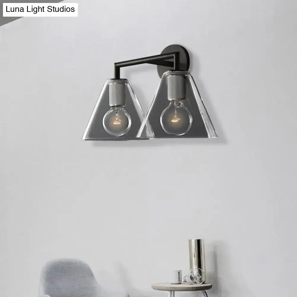 Modern black metal dual-light wall light with smoked glass cone shades and exposed filaments direct wired electric