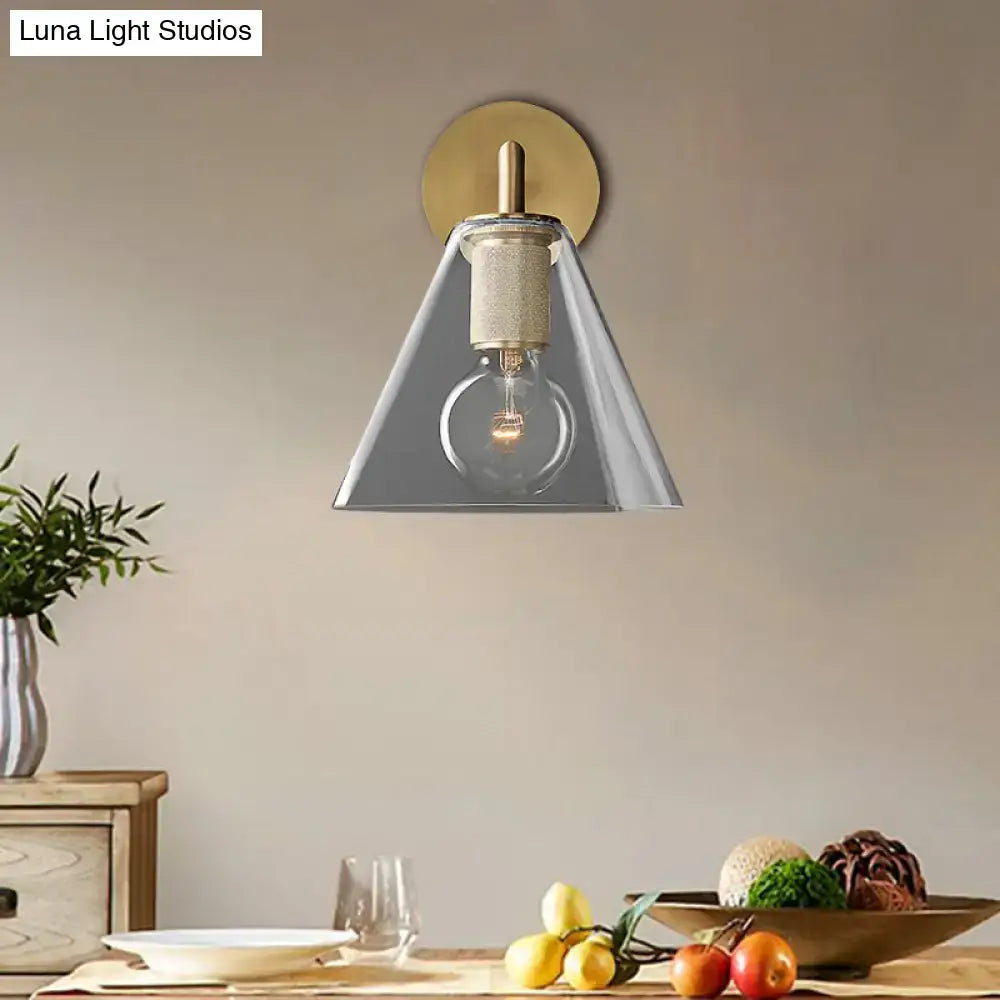 Modern black and brass glass cone wall light with direct wired electric installation featuring a gold and gray design