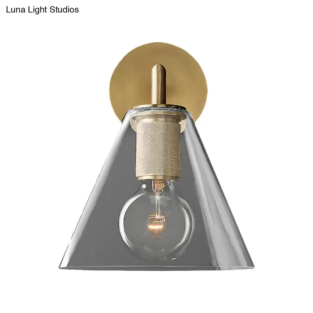 Modern black and brass glass cone wall light with clear glass shade and textured metallic accents direct wired electric