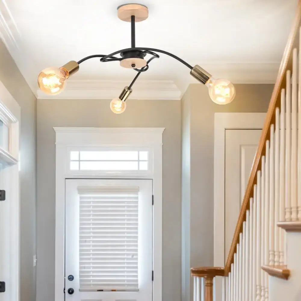 Modern black and brass iron wrought ceiling light fixture with three exposed bulbs for dining room decorbites style
