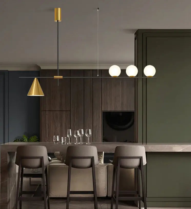 Modern linear chandelier with gold-finished top, black rod, and three spherical white glass bulbs for dining room