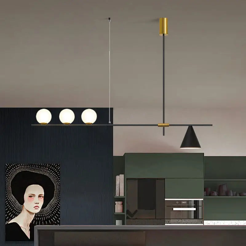 Modern black and brass linear chandelier with three spherical white glass bulbs and a sleek metal frame for dining room
