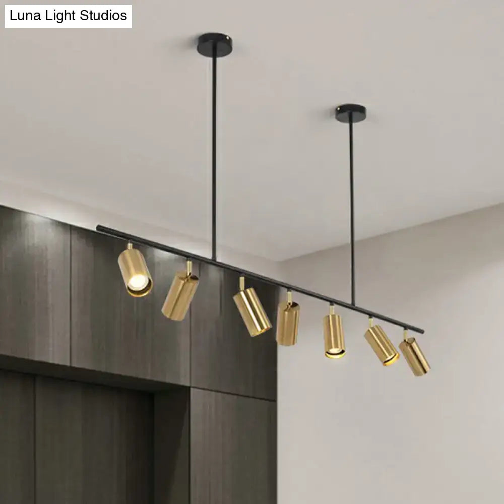 Modern gold finished metal island ceiling light with cylindrical tube spotlight and black mounting hardware for dining room