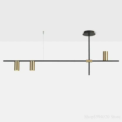 Modern black and brass minimalist linear pendant light with cylindrical fixtures for black minimalist dining decorbites