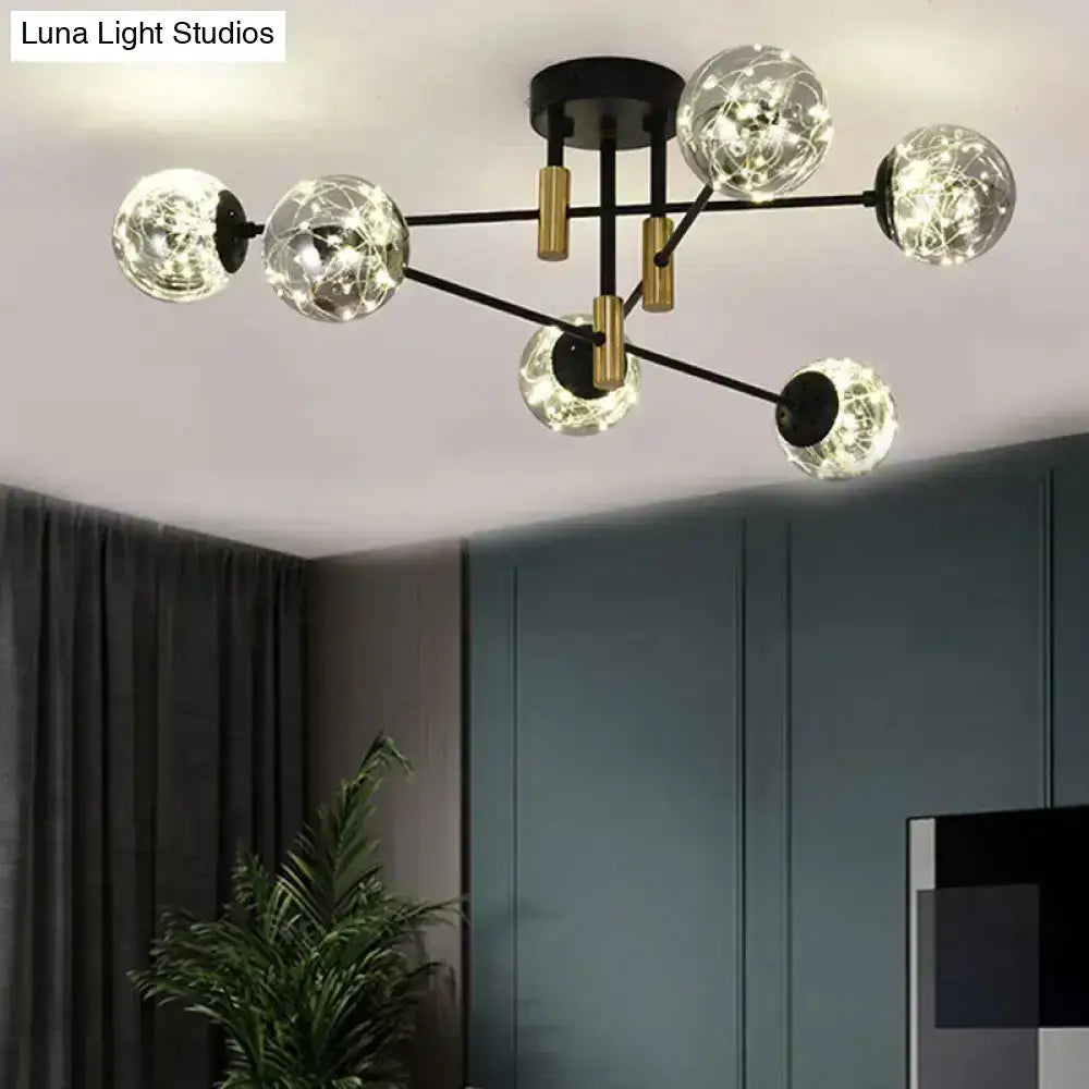 Modern black and gold nordic ball semi flush chandelier with six smoke glass globes and glowing fairy lights for living room