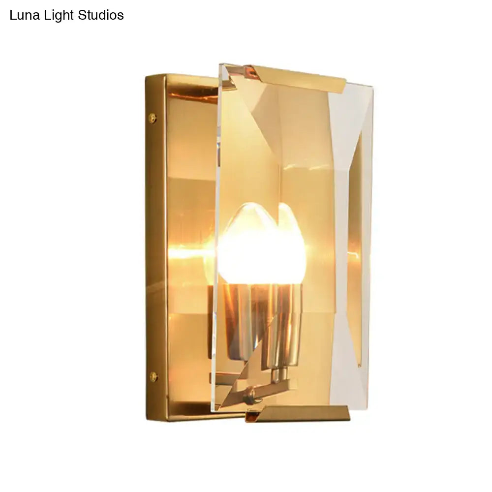 Modern black brass sconce light with gold-toned geometric design featuring clear acrylic and polished metal accents