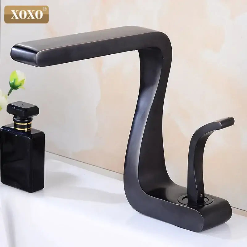 Modern black brass single handle basin faucet with sleek curved design in matte finish by decorbites for bathroom sink