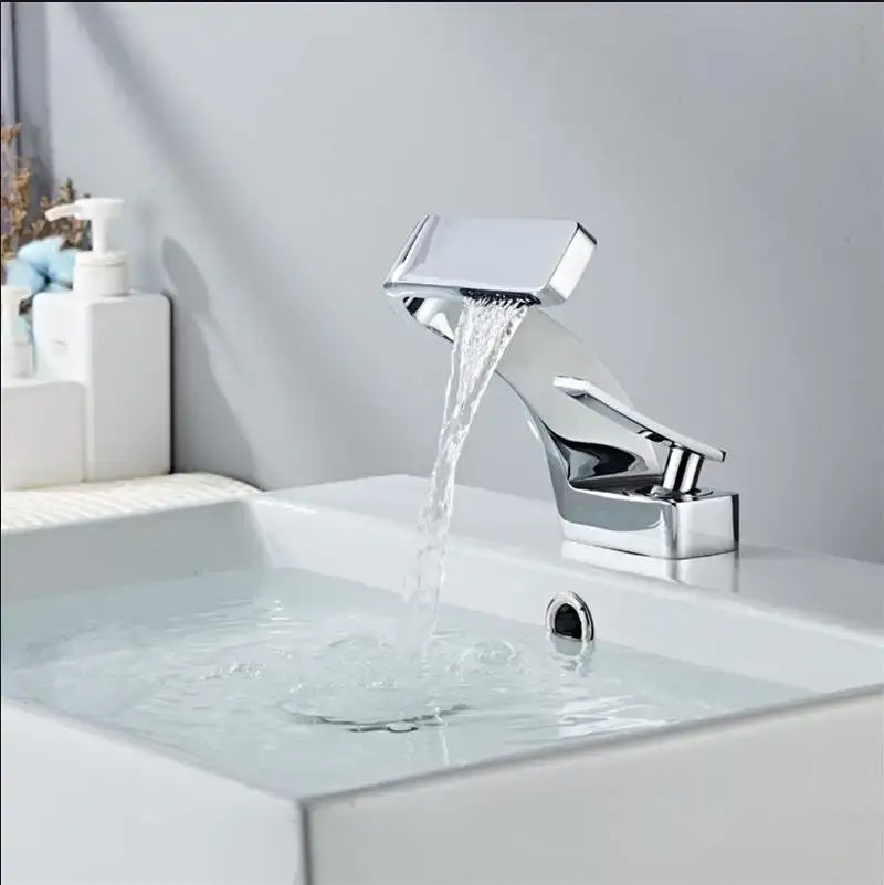 Modern black and brushed gold decorbites basin faucet with chrome finish and sleek angular waterfall design for bathroom use