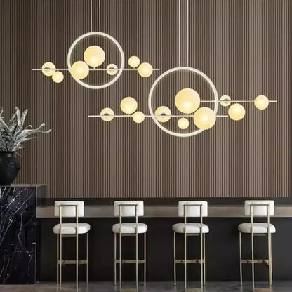 Modern black bubble glass pendant light with interconnected circular frames and warm yellow spherical bulbs decorbites bubble glass