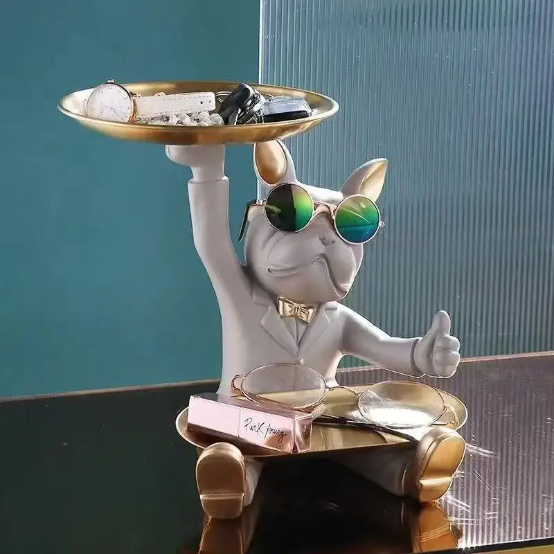 A stylish white bulldog tray statue wearing green sunglasses and a gold bow tie holding a golden tray for living room storage