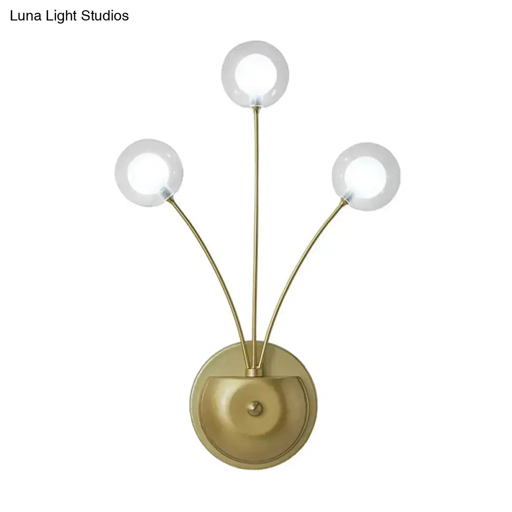 Brass-finished cast iron wall sconce with three clear glass globes and curved arms measures inches fixture for living room lighting