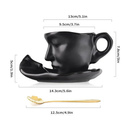 Modern black ceramic tea cup set sculpted with a serene face featuring closed eyes ideal for latte art and dining room use
