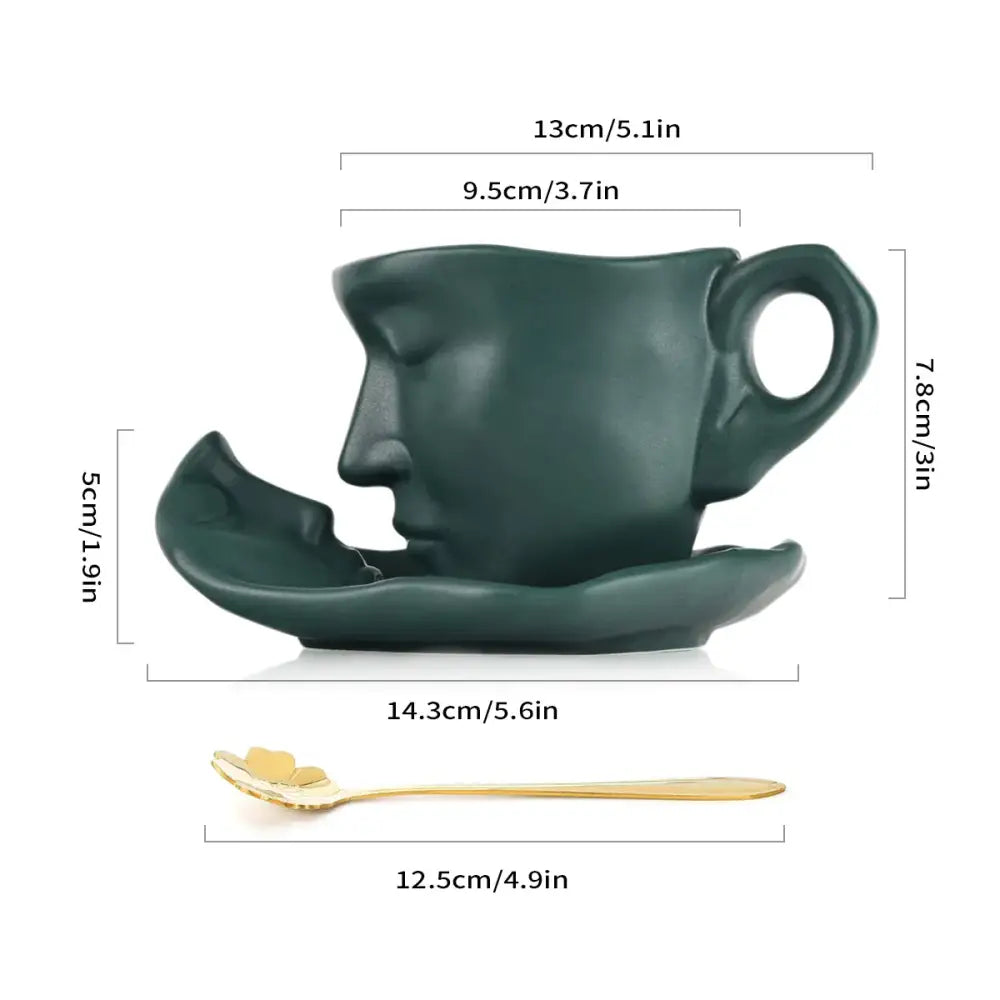 Modern black ceramic tea cup set featuring a dark green face-shaped cup with closed eyes and matching saucer
