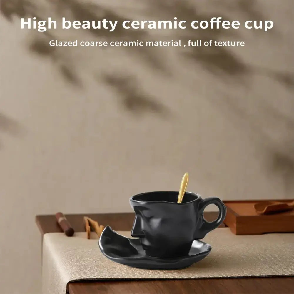 Modern black ceramic tea cup set with glazed coarse texture and face design on cup and matching saucer for dining room