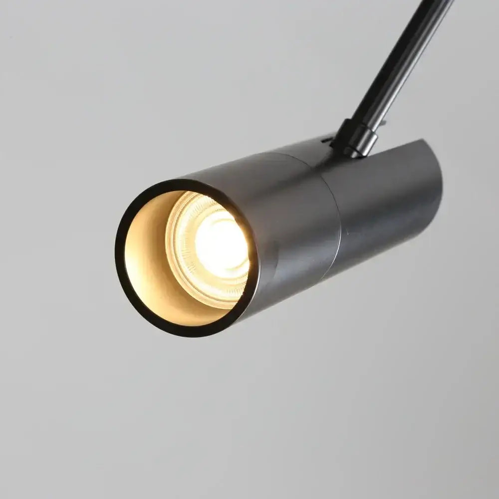 Modern black chandelier pendant light with a warm glowing bulb for bedroom decor featuring a decorbites black chandelier design