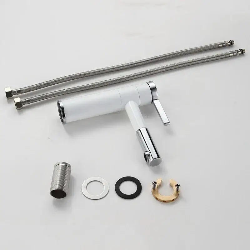 Modern black and chrome brass bathroom faucet with white ceramic lever handle and flexible metal hoses by decorbites brass bathroom