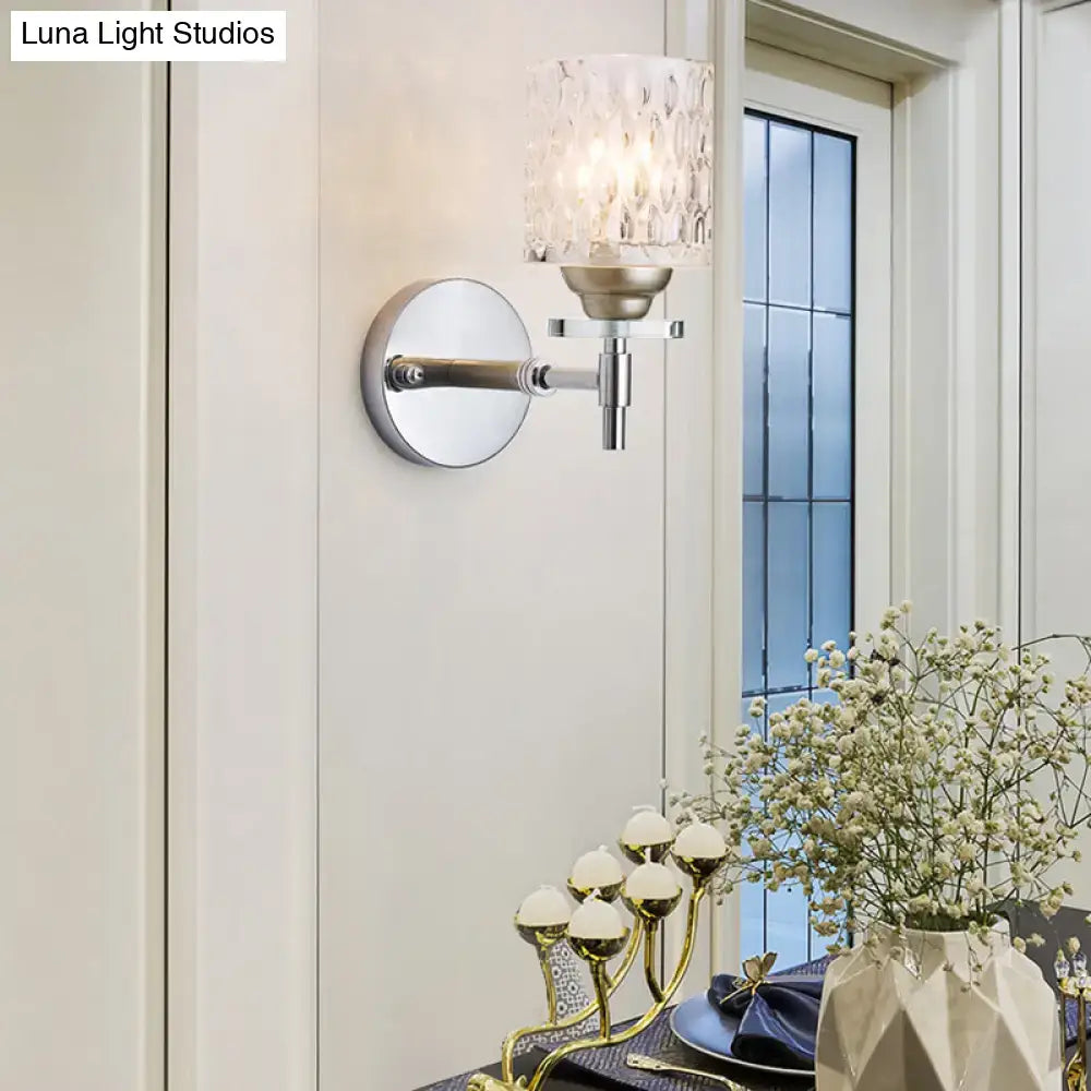 Modern black chrome wall sconce with dimpled glass cylinder shade and brushed nickel finish for bedroom lighting