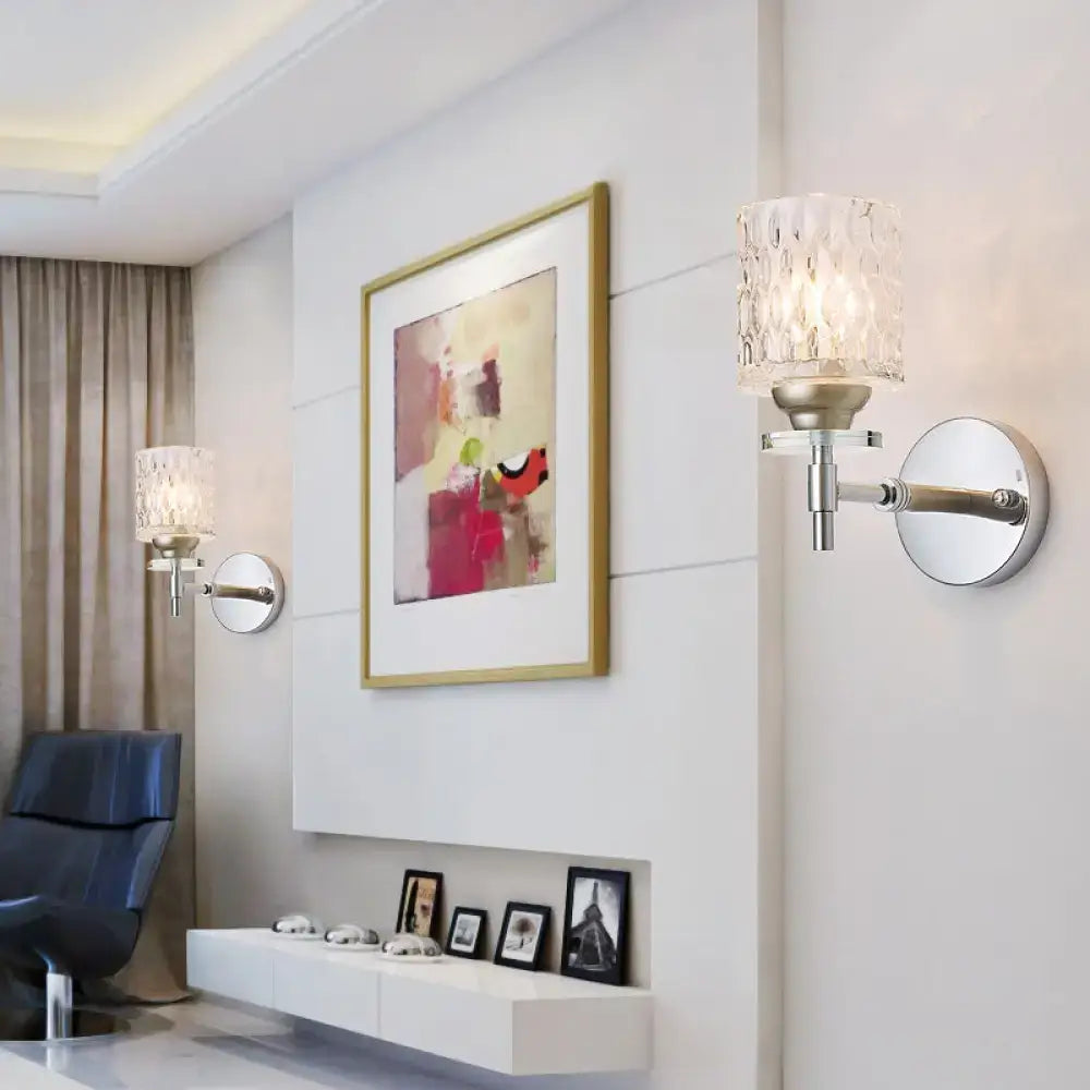 Modern black chrome wall sconce with dimpled glass cylinder and silver-finished textured faceted crystal shade