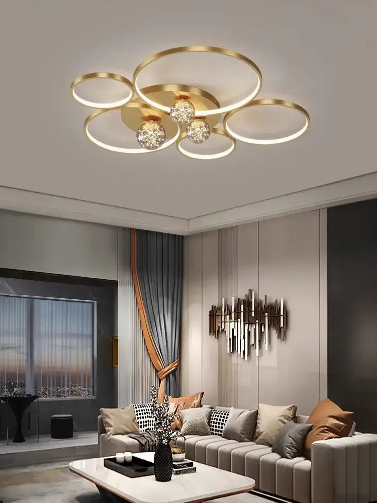 Gold-toned decorbites gypsophila chandelier with interconnected rings and crystal globe bulbs for modern living room decor