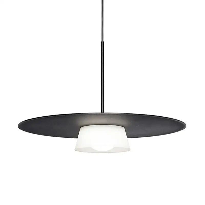 Modern black pendant light with a circular metal shade and frosted glass diffuser for decorbites circular coffee shop decor