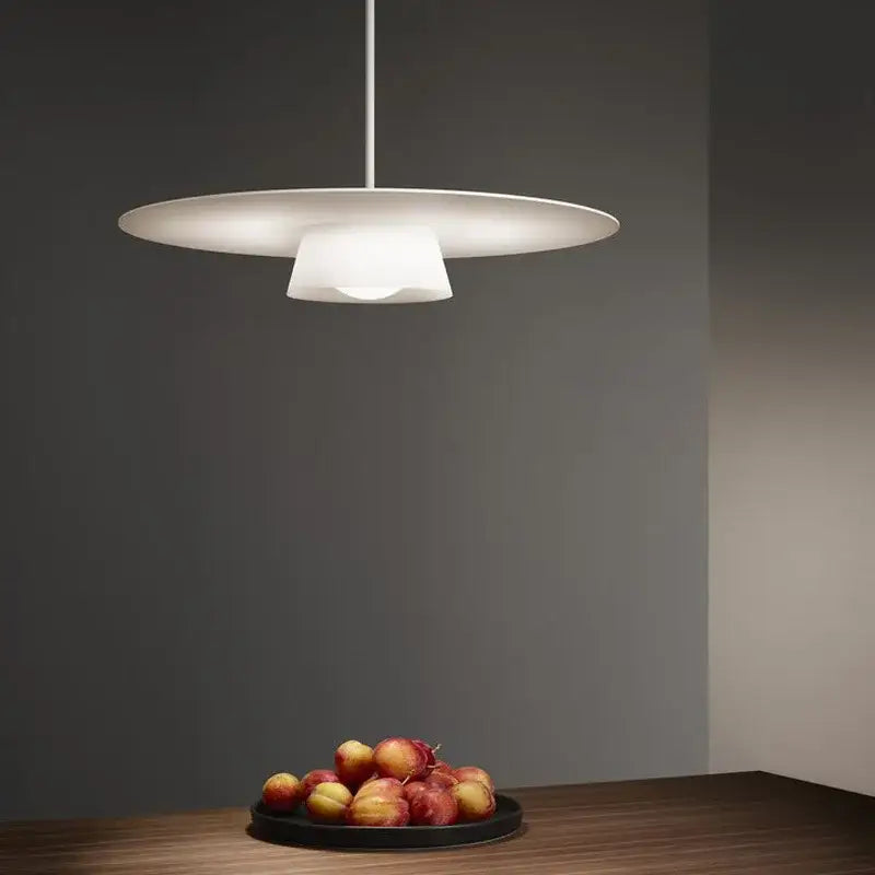 Modern white pendant light with disc-shaped design and frosted glass diffuser for decorbites circular coffee shop decor