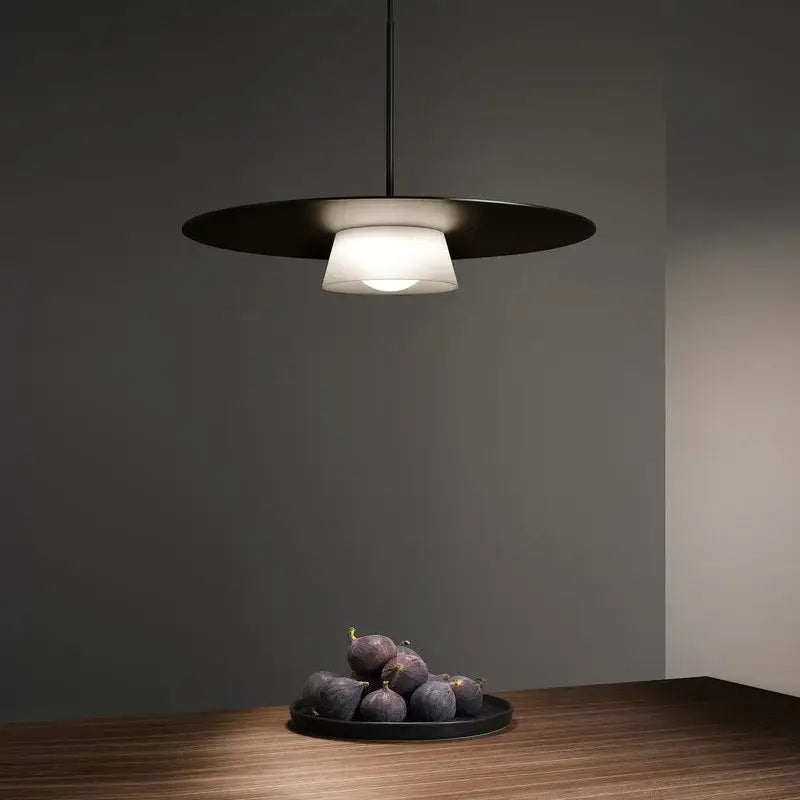 Modern black pendant light with frosted glass shade from decorbites circular coffee shop collection for dining room decor