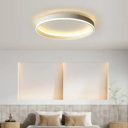 Modern black decorbites circular led ceiling light with sleek white and metallic finish emitting warm ambient glow