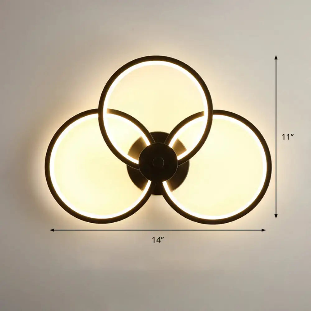 Modern black circular led light fixture bedroom wall sconce with three overlapping illuminated rings and remote control