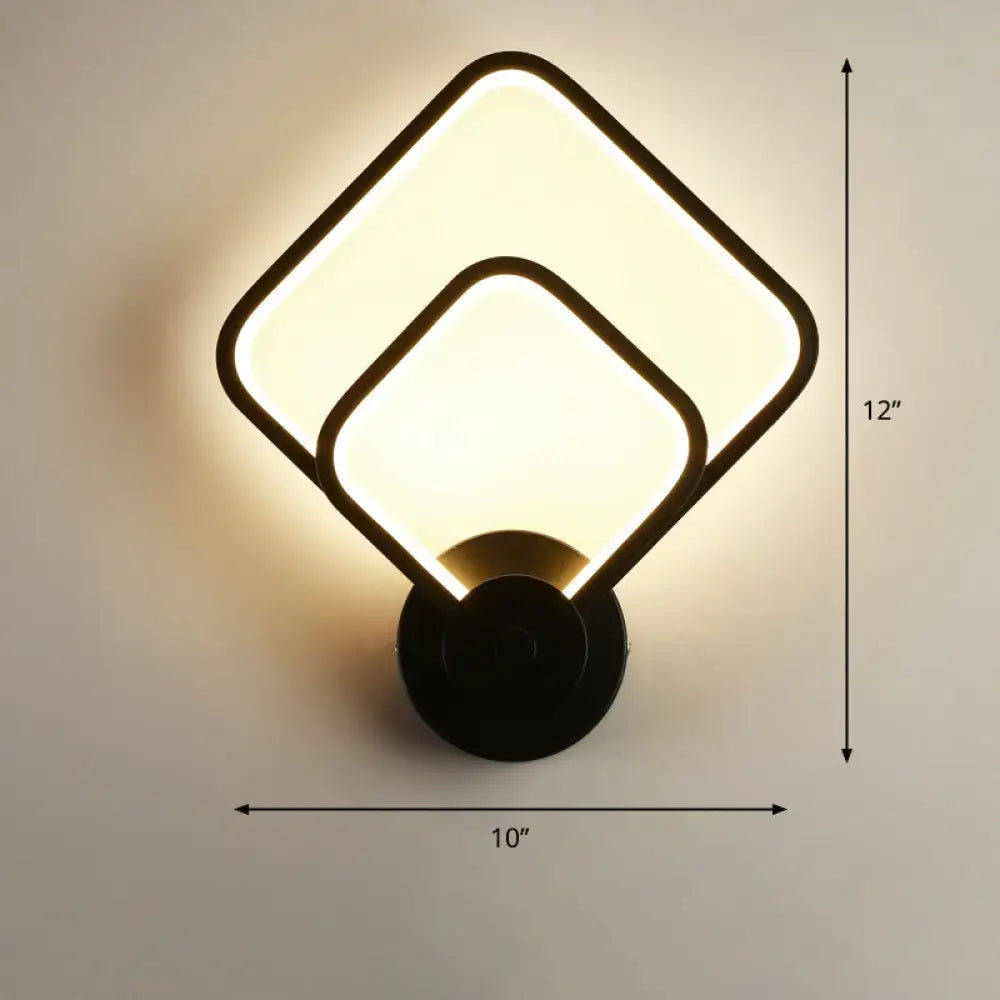 Modern black circular led light fixture wall sconce with overlapping square panels emitting warm glow and remote control feature
