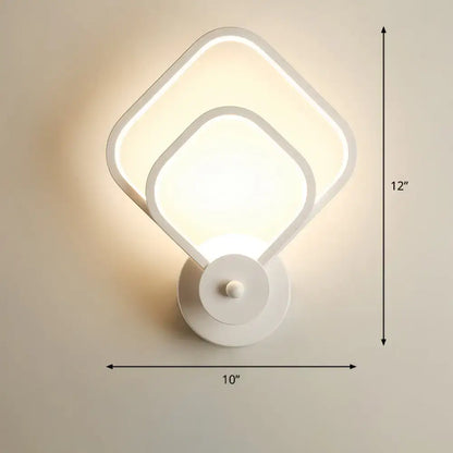 Modern white led wall sconce with overlapping square panels paired with a modern black circular led light fixture remote control