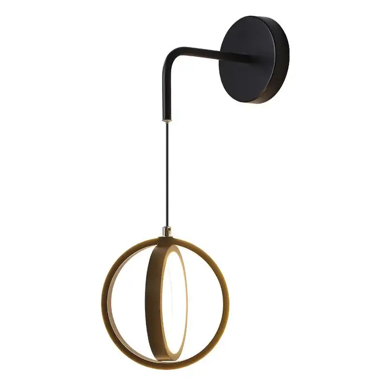 Modern black wall sconce light with sleek curved arm and illuminated circular ring ideal for bedroom lighting