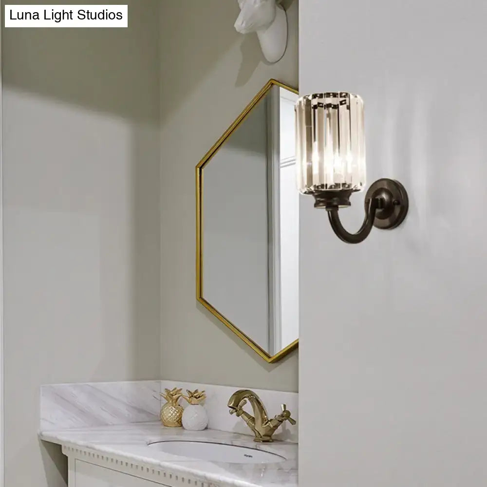 A sleek vintage-inspired wall lamp with dark bronze finish and clear crystal drum glass panels for living room use