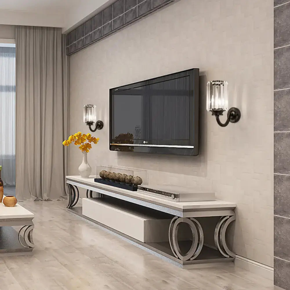 Modern black clear crystal drum wall lamp mounted above a white and silver media console with lg flat-screen tv