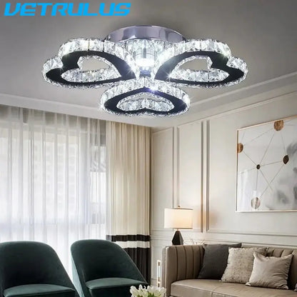 A modern black and clear crystal led ceiling chandelier with four acrylic rings and chrome decorbites crystal led mount