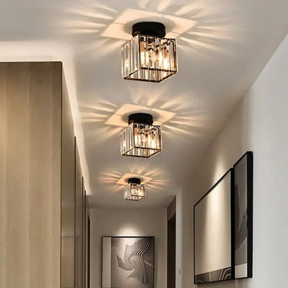 Modern black and clear crystal led ceiling light with vertical glass rods and warm radiant illumination by decorbites crystal led