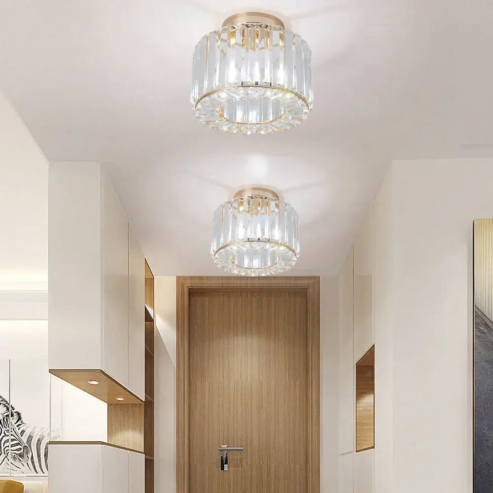Two elegant gold-toned decorbites crystal led ceiling lights with clear crystal prisms for modern bedroom decor