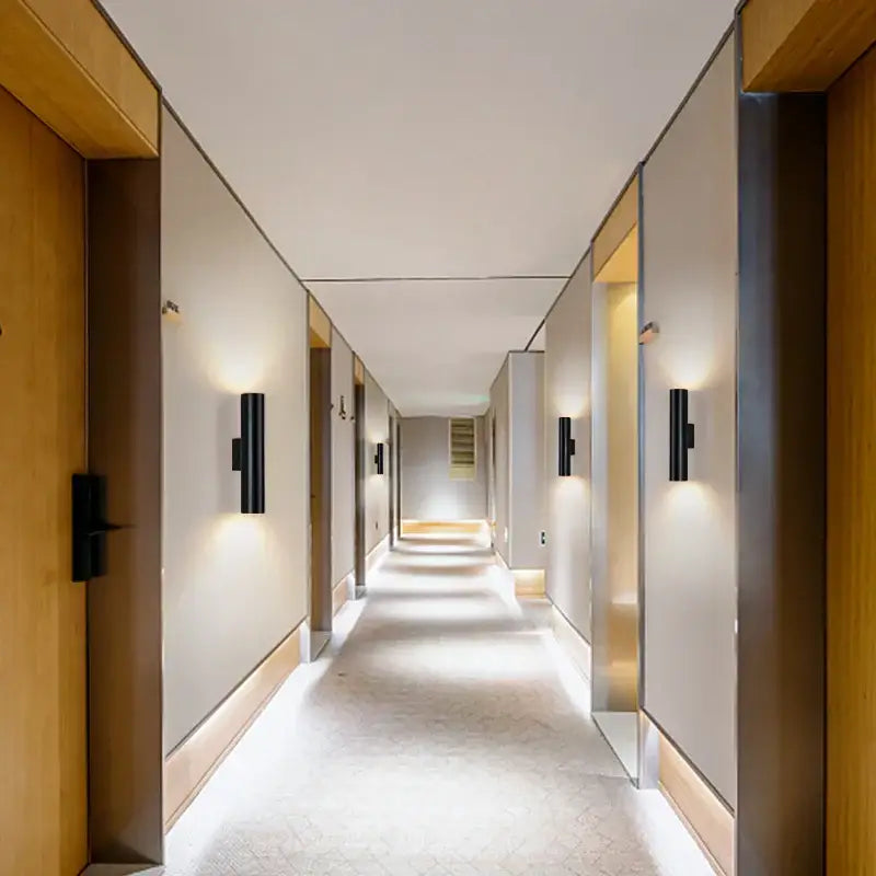 Modern black cylindrical wall lamp with decorbites cob led for sleek up down lighting in bedroom sconce design