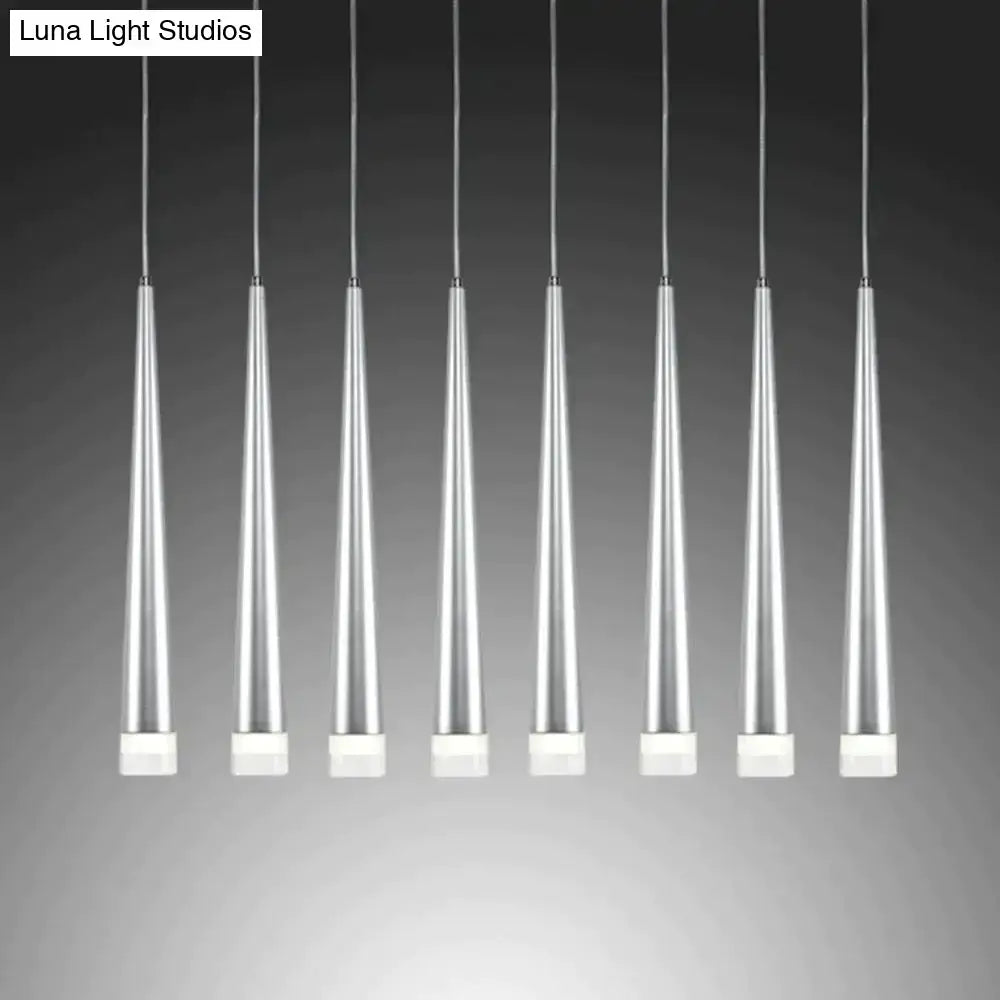 Seven sleek silver-toned modern black conical led pendant lamps with white square bases hang in uniform alignment for kitchen islands