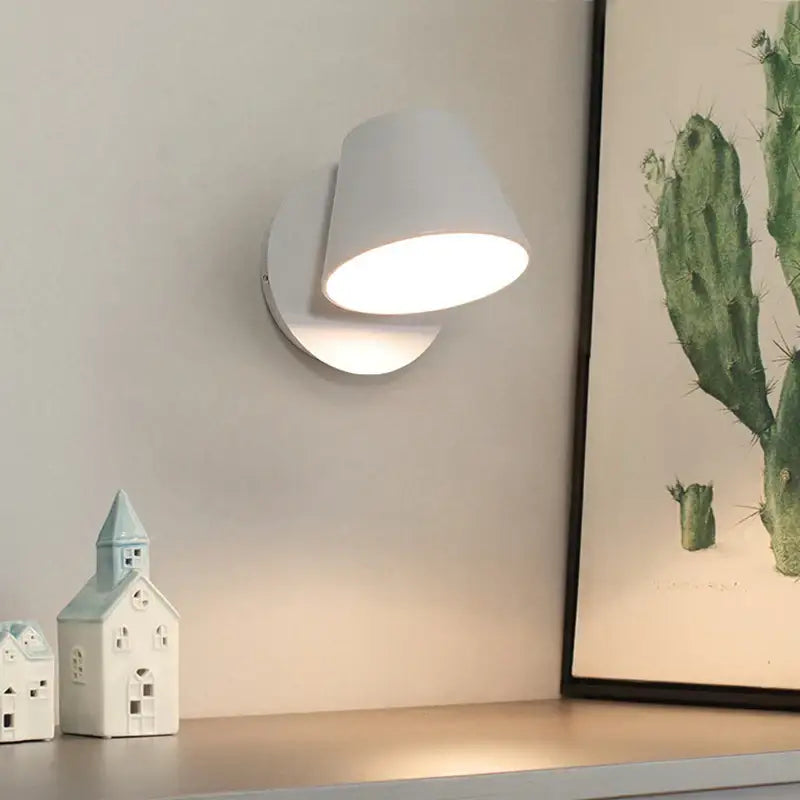 White ceramic wall lamp with sleek modern design and adjustable led lighting for bedroom reading use