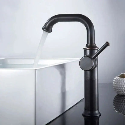 Modern black matte basin faucet with curved spout and single lever handle in decorbites black antique brass finish over white sink