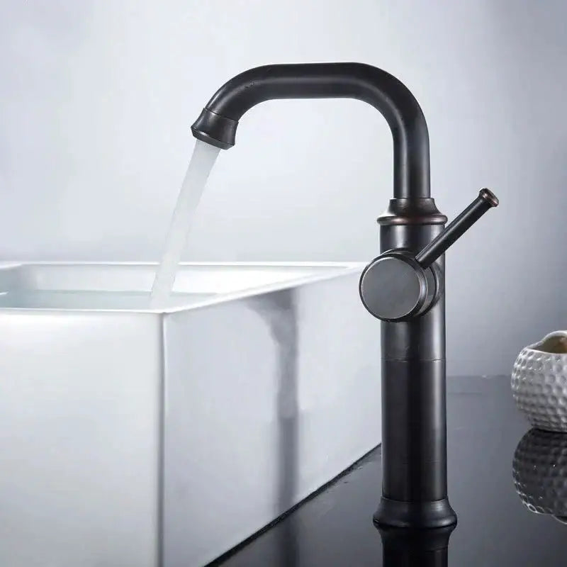 Modern black matte basin faucet with curved spout and single lever handle in decorbites black antique brass finish over white sink
