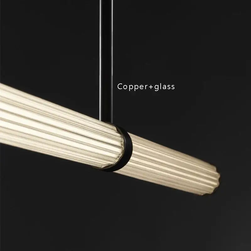 Modern black copper glass pendant dining room lamp with sleek ribbed glass tube and warm illumination by decorbites black copper