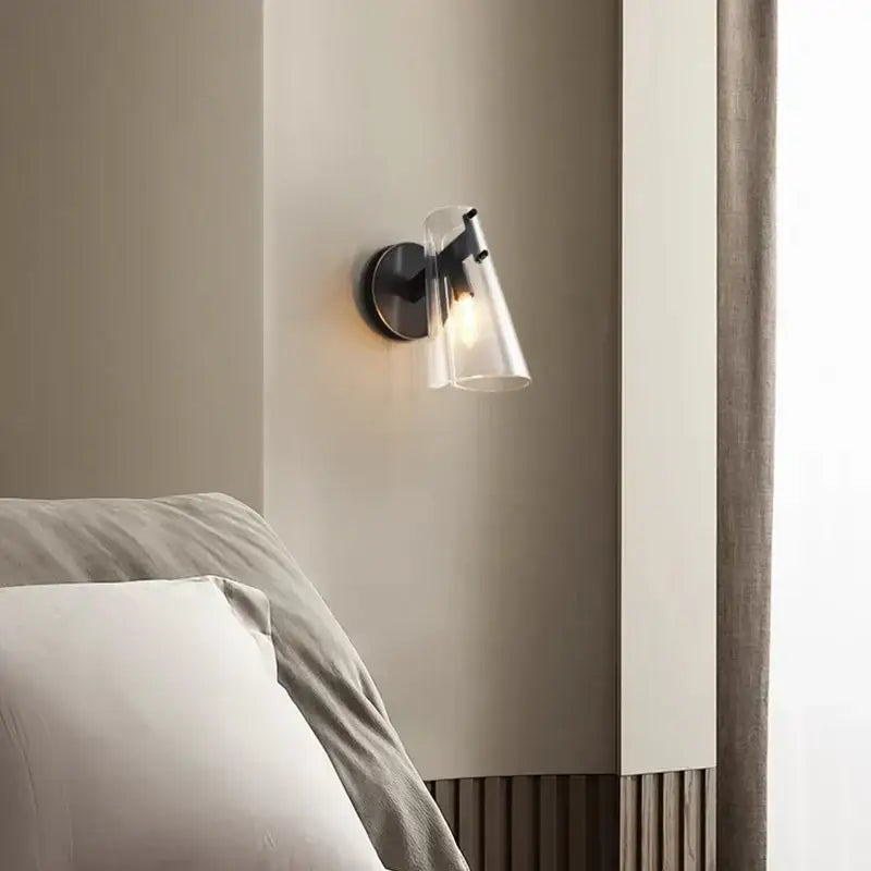Modern black copper wall lamp with clear glass cone-shaped shade ideal for bedroom lighting decorbites black copper