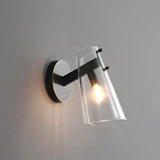 Modern black copper wall lamp featuring a metal frame with a clear glass shade ideal for bedroom decorbites black copper designs