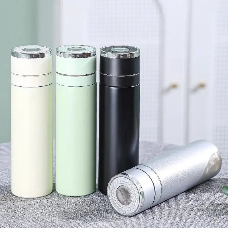 Three sleek 400ml stainless steel vacuum tumblers in matte cream black and mint green with silver lids for travel use